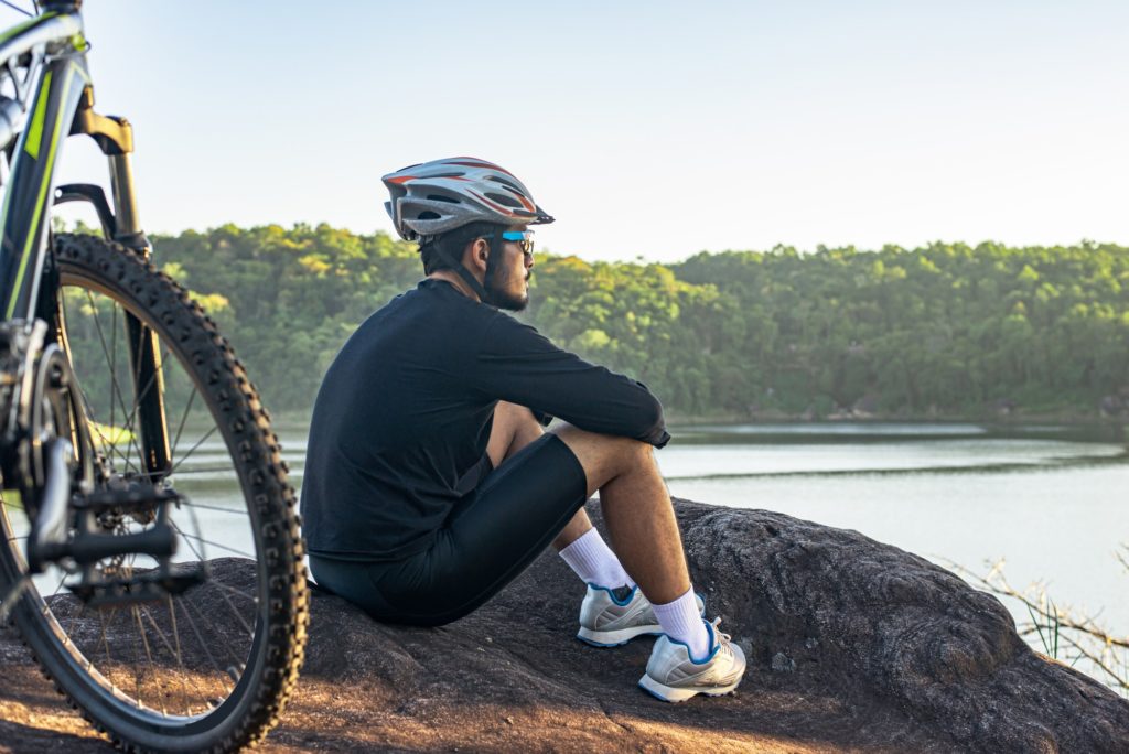 Athletes sitting on the mountain with bicycle