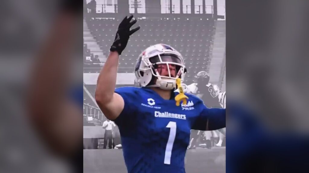 Boogie Knight in his No. 1 SEKISUI Challengers jersey raising his arm in a Japanese stadium